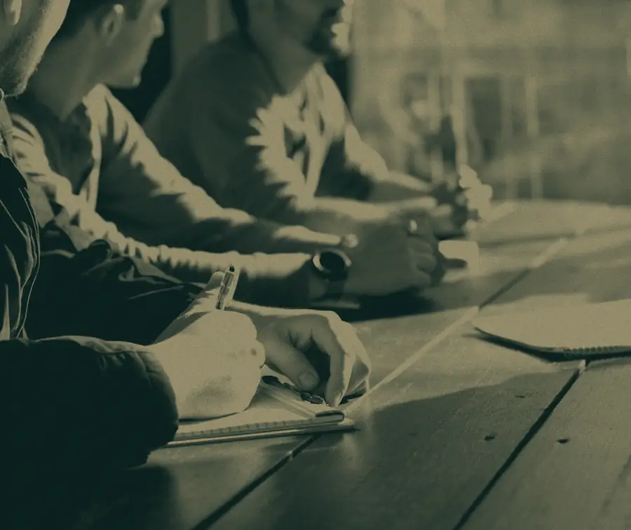 Three people working through figures around a table.